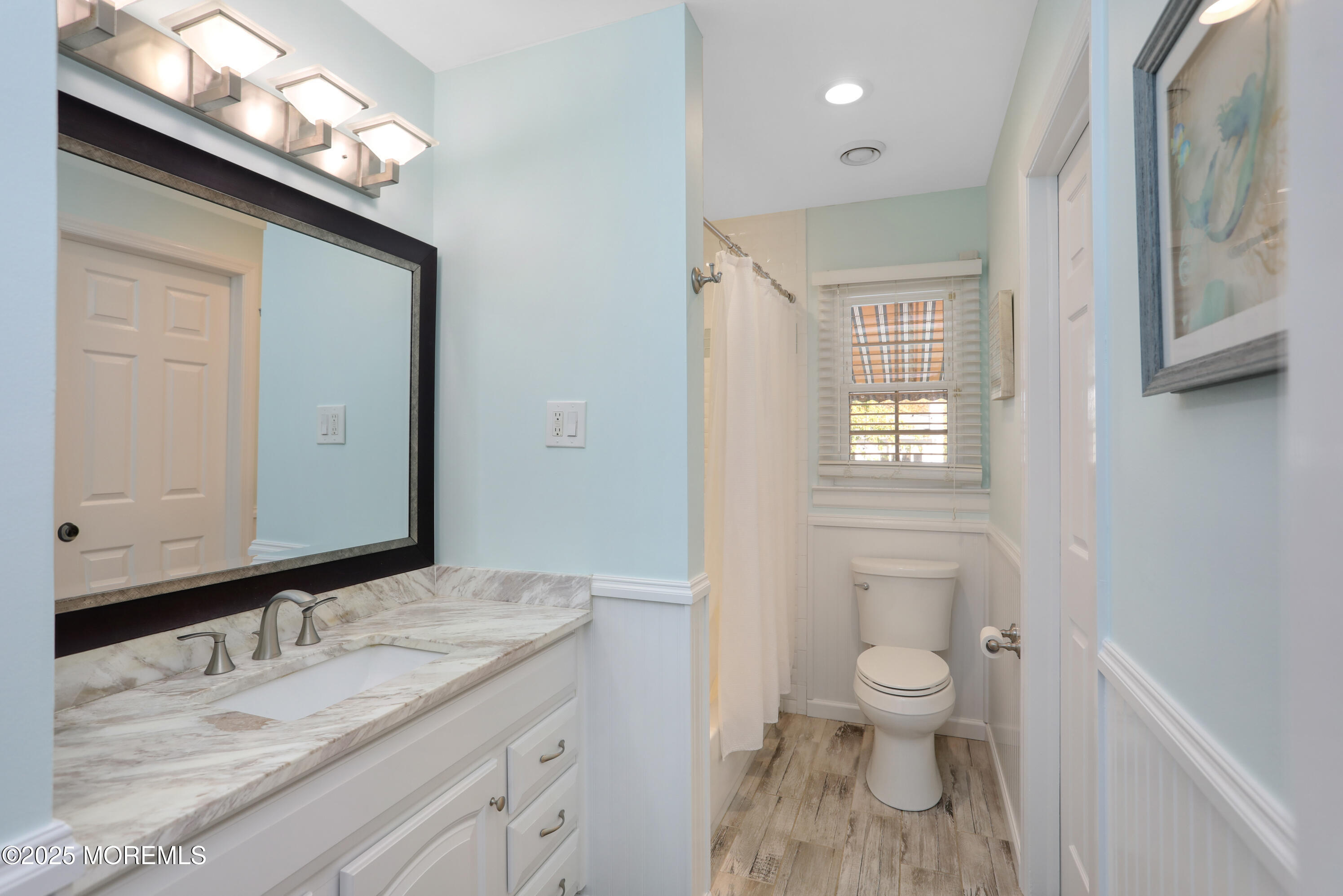 910 Ocean Road Spring Lake Heights, NJ 07762 - Photo 16 of 31 a bathroom with a granite countertop sink a toilet and a mirror