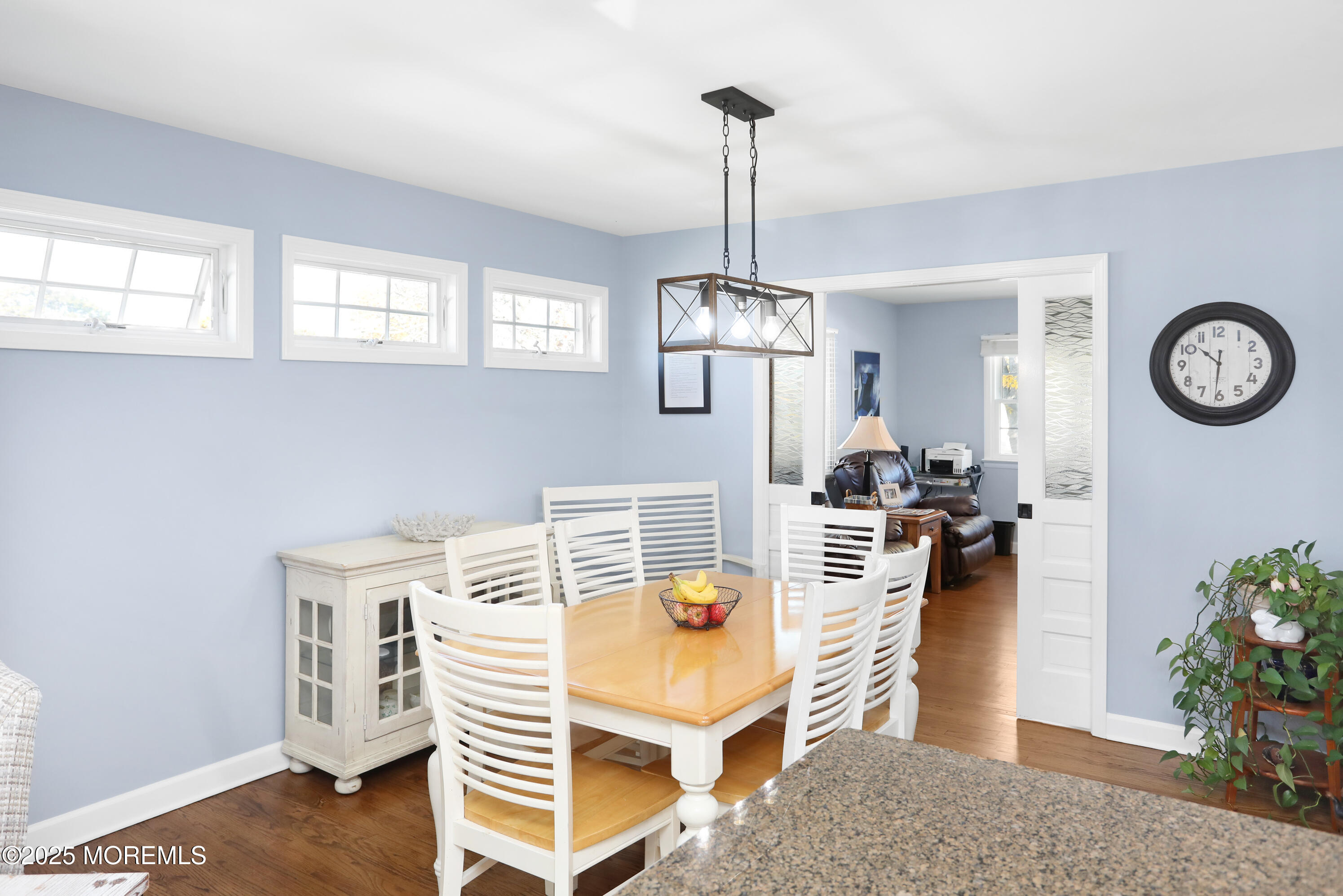 910 Ocean Road Spring Lake Heights, NJ 07762 - Photo 8 of 31 a view of a dining room and a livingroom with furniture wooden floor a chandelier