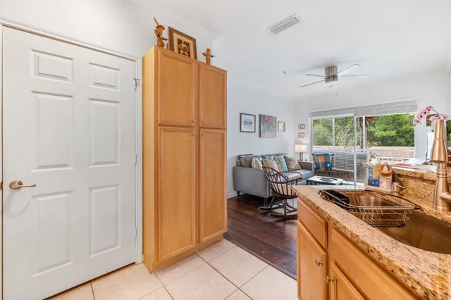 a kitchen with granite countertop a sink and a refrigerator