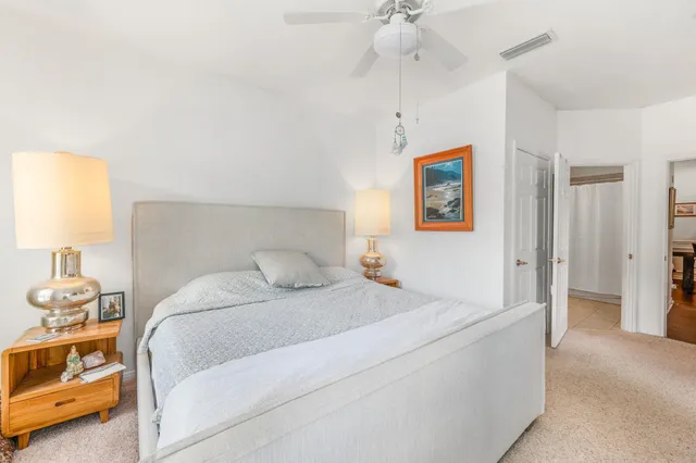 a bedroom with a large bed and a window