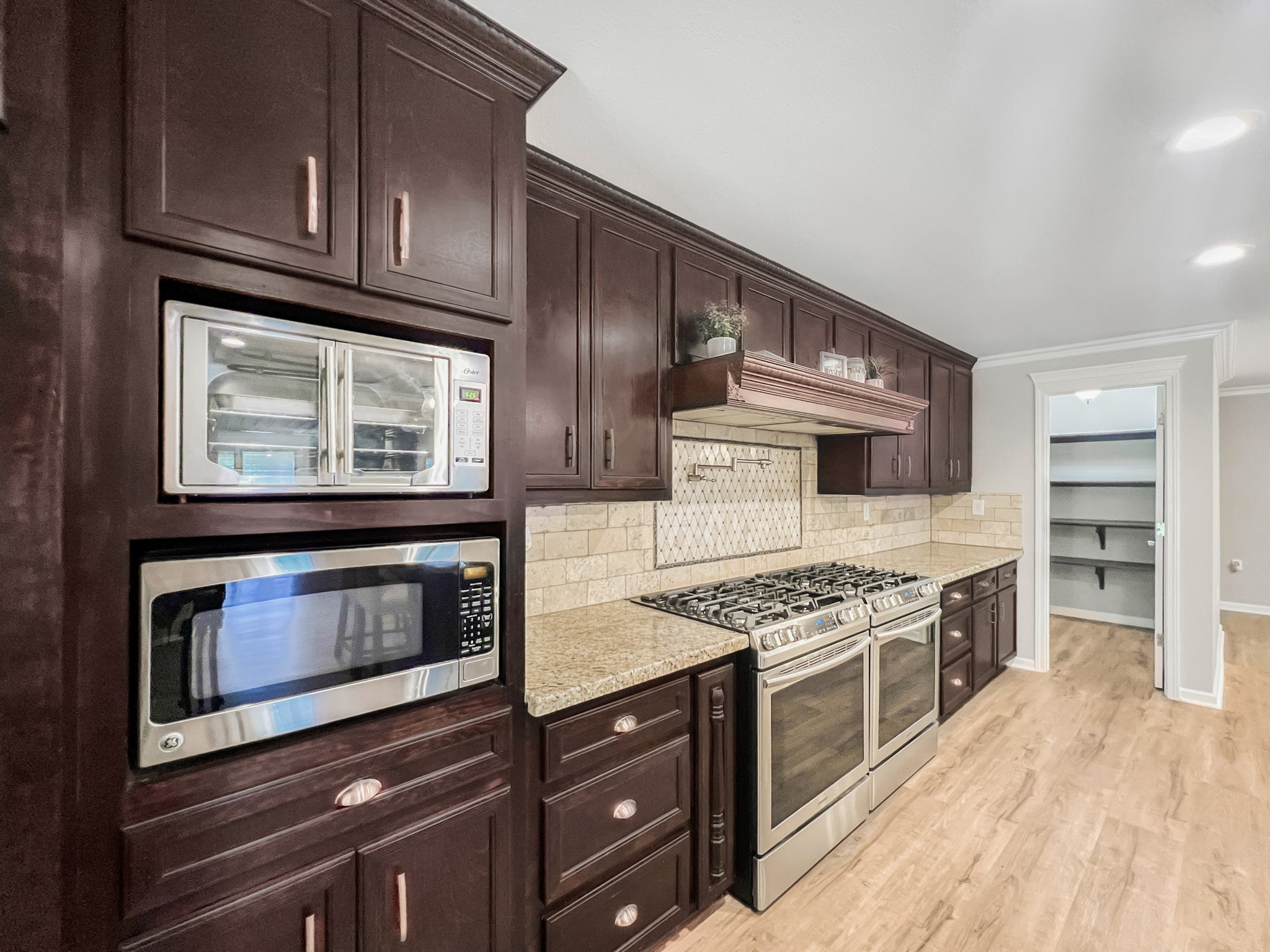 9731 Hadden Road Baytown, TX 77521 - Photo 16 of 47 a kitchen with stainless steel appliances granite countertop a stove and a microwave