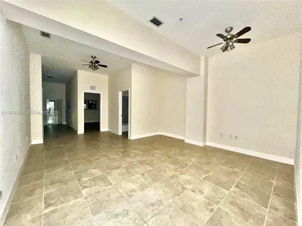 a view of a room with a ceiling fan