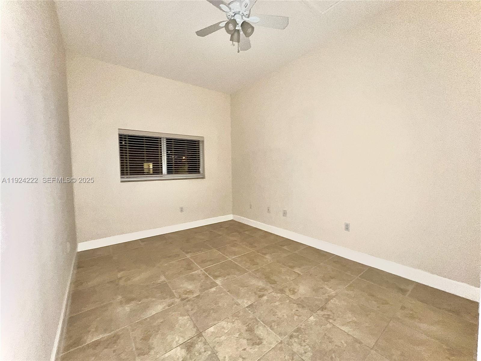 1253 Southwest 2nd Street, Unit 209 Miami, FL 33135 - Photo 4 of 11 an empty room with a window