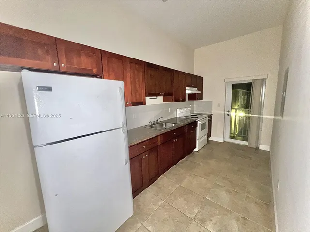 a white refrigerator freezer sitting in a kitchen
