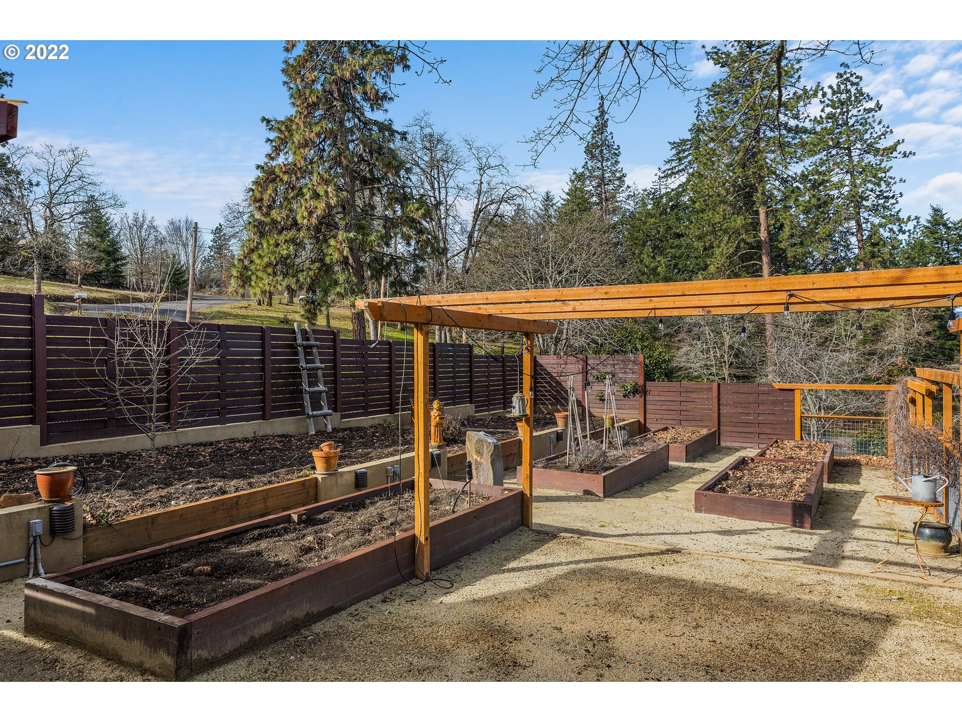 515 Highline Road Hood River, OR 97031 - Photo 16 of 32 a view of a patio with table and chairs with wooden fence
