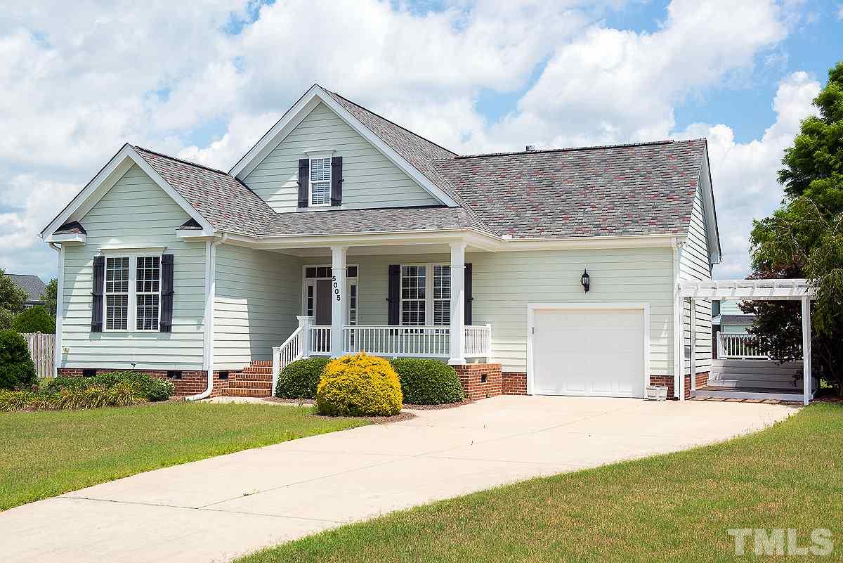 a front view of a house with a yard and porch