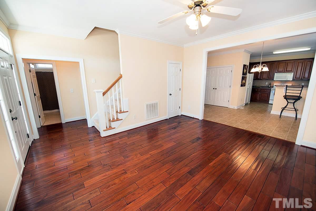 5005 Contender Drive Raleigh, NC 27603 - Photo 3 of 21 a view of empty room with wooden floor and fan