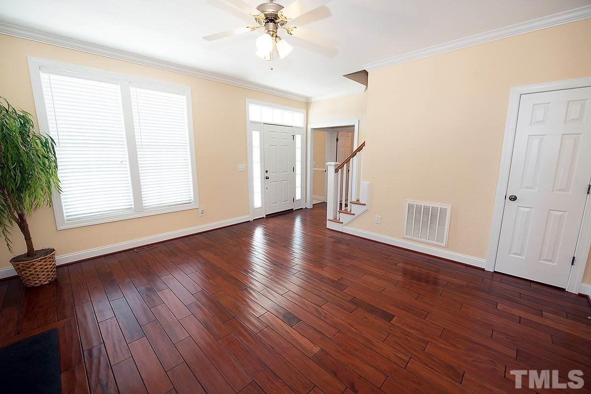 5005 Contender Drive Raleigh, NC 27603 - Photo 5 of 21 a view of an empty room with wooden floor and a window