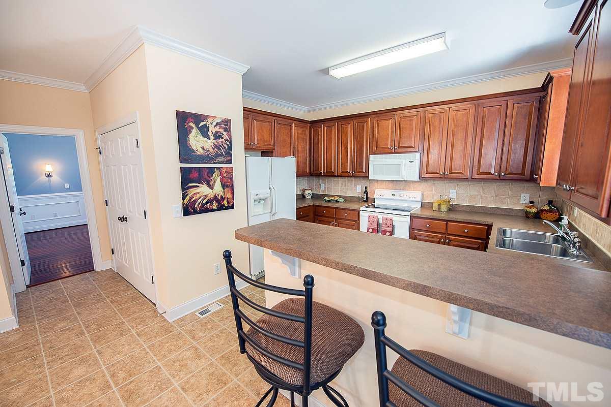 5005 Contender Drive Raleigh, NC 27603 - Photo 8 of 21 a kitchen with stainless steel appliances granite countertop a refrigerator sink and cabinets