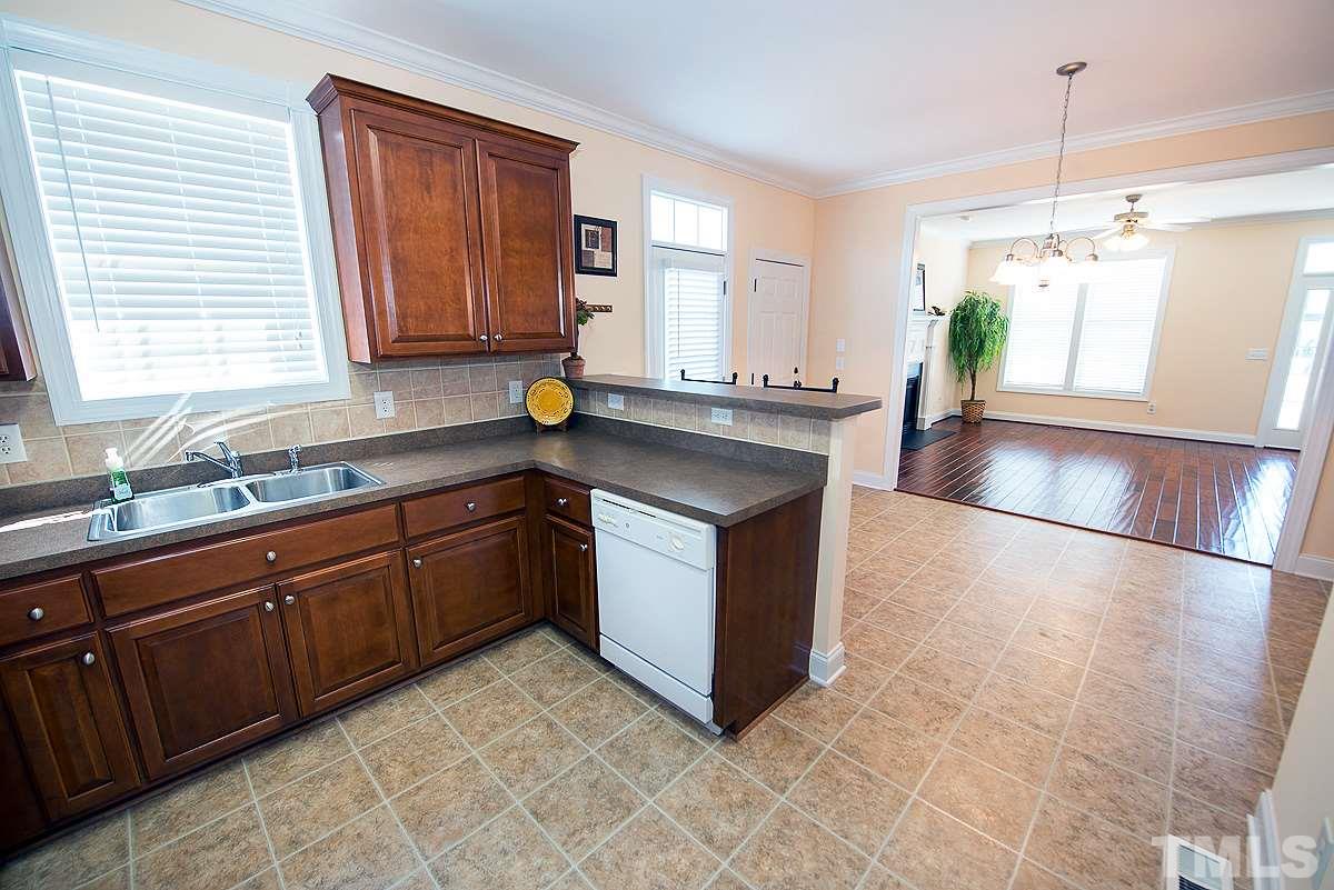 5005 Contender Drive Raleigh, NC 27603 - Photo 9 of 21 a kitchen with stainless steel appliances granite countertop a sink and a stove