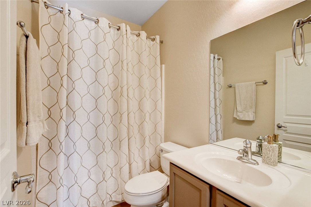 2649 Rue Marquette Avenue Henderson, NV 89044 - Photo 34 of 55 This bathroom features a shower-tub combination and a vanity with a sleek countertop and ample storage.
