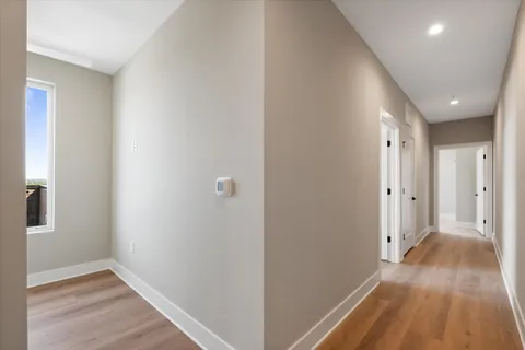a view of hallway with wooden floor