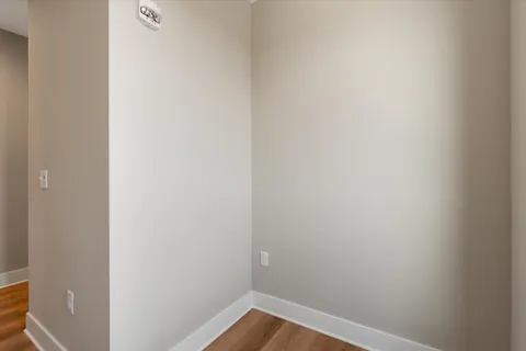 an empty room with a window and a ceiling fan