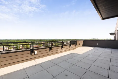 a view of balcony with outdoor seating and city view