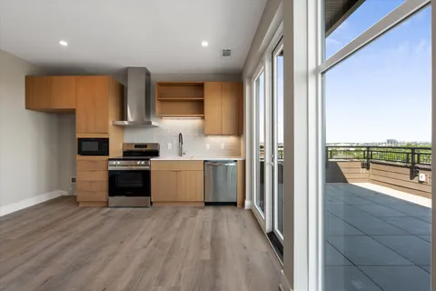 a kitchen with stainless steel appliances a refrigerator and a stove top oven