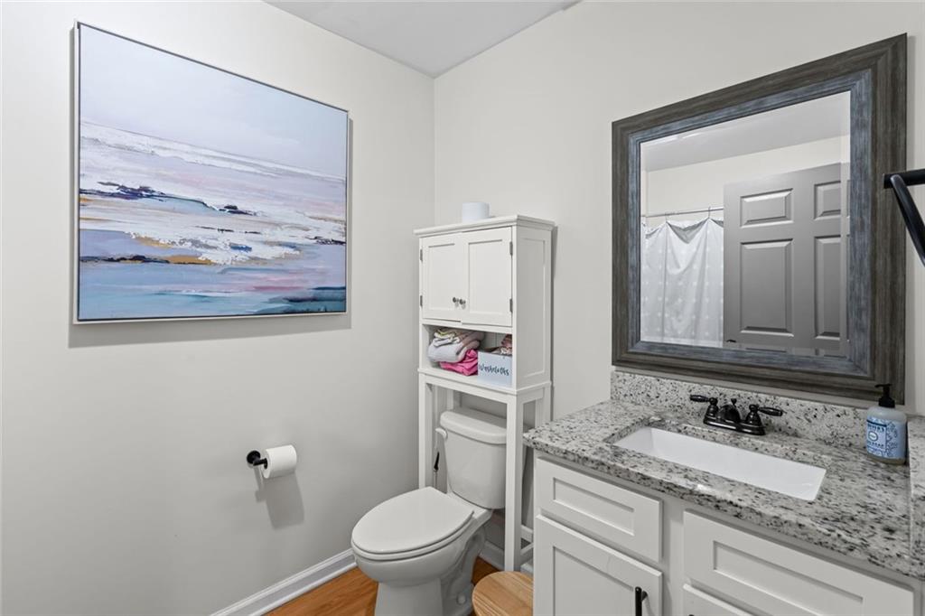 3675 Rosedale Circle Gainesville, GA 30506 - Photo 18 of 32 a bathroom with a granite countertop sink mirror vanity and toilet
