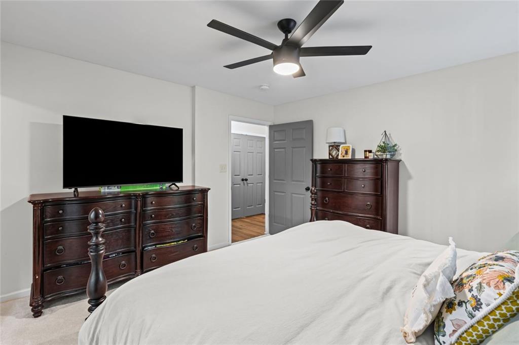 3675 Rosedale Circle Gainesville, GA 30506 - Photo 20 of 32 a bedroom with a bed and a flat screen tv in white dresser