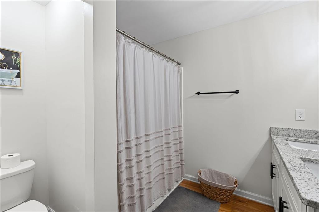 3675 Rosedale Circle Gainesville, GA 30506 - Photo 21 of 32 a bathroom with a granite countertop toilet and a sink