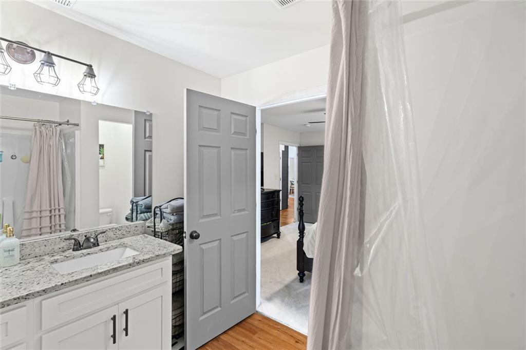 3675 Rosedale Circle Gainesville, GA 30506 - Photo 22 of 32 a bathroom with a granite countertop sink and a mirror