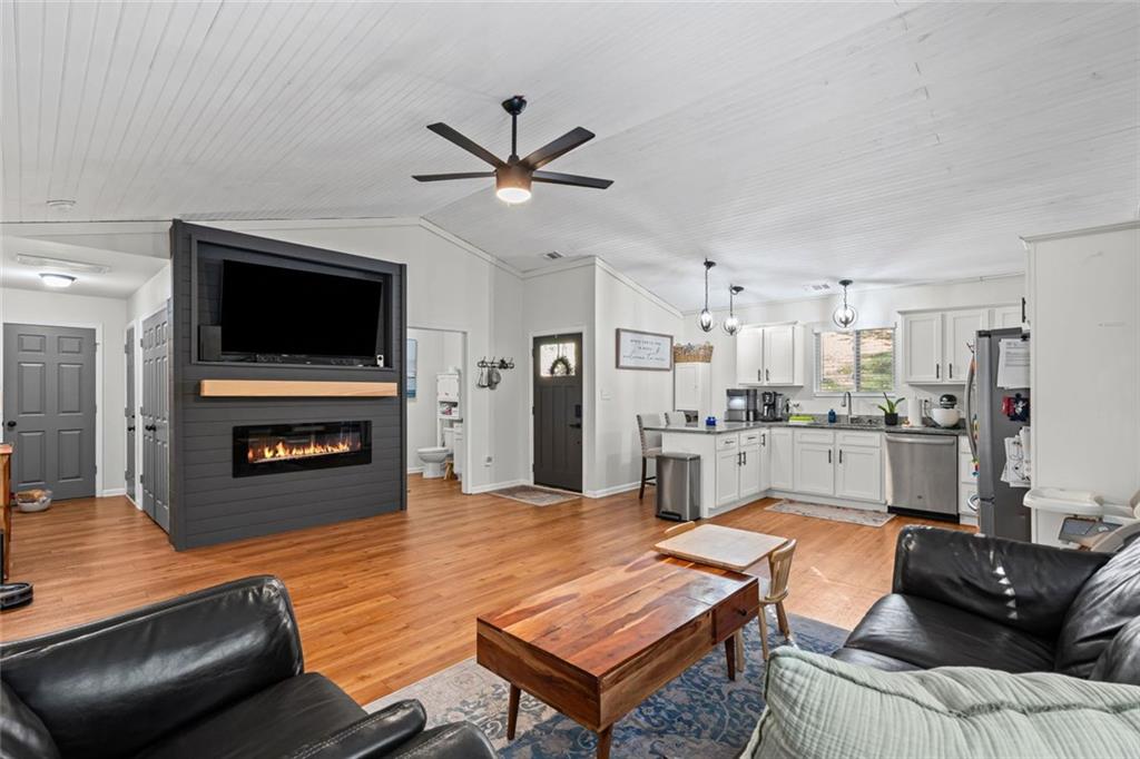 3675 Rosedale Circle Gainesville, GA 30506 - Photo 9 of 32 a living room with stainless steel appliances furniture a fireplace a flat screen tv and view kitchen