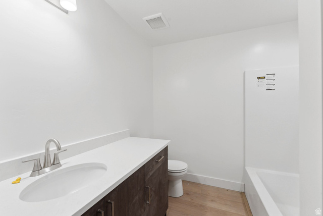 1617 North Angel Street Layton, UT 84041 - Photo 24 of 43 Full bath featuring vanity, a tub to relax in, and light wood finished floors