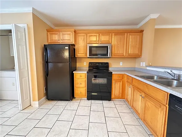 a kitchen with stainless steel appliances a refrigerator sink and cabinets