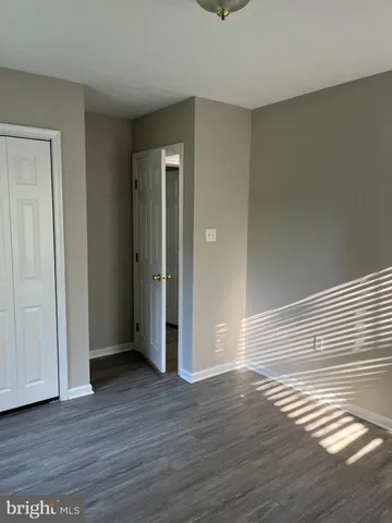 a view of wooden floor and windows in a room