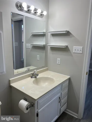 a bathroom with a sink vanity and a mirror