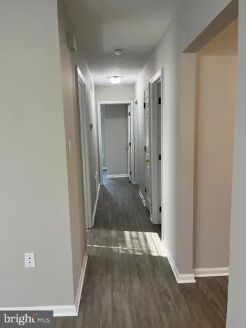 a view of hallway with wooden floor