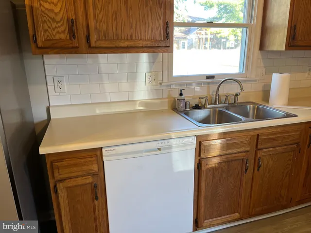 a kitchen with a sink cabinets and window