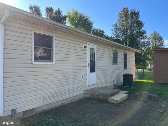 a view of a white house with a small yard and a large window