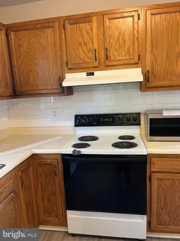a kitchen with stainless steel appliances a stove and a microwave