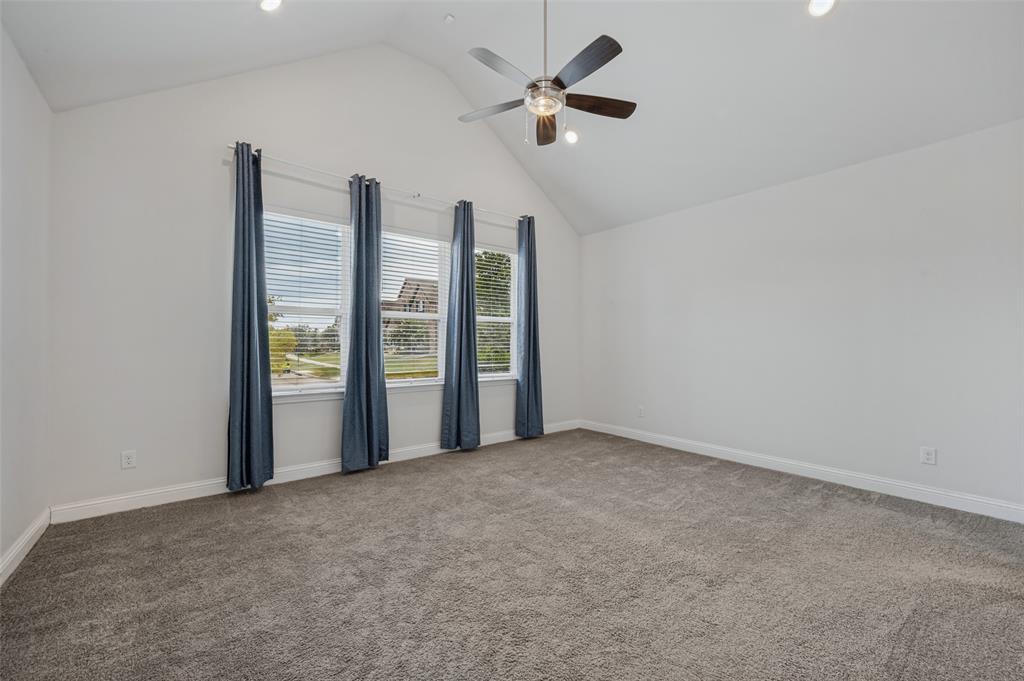 15862 Shasta Daisy Road Frisco, TX 75035 - Photo 6 of 15 Spacious Primary Bedroom with vaulted ceiling, ceiling fan, recessed lighting, plush grey carpeting, and three windows with white blinds.