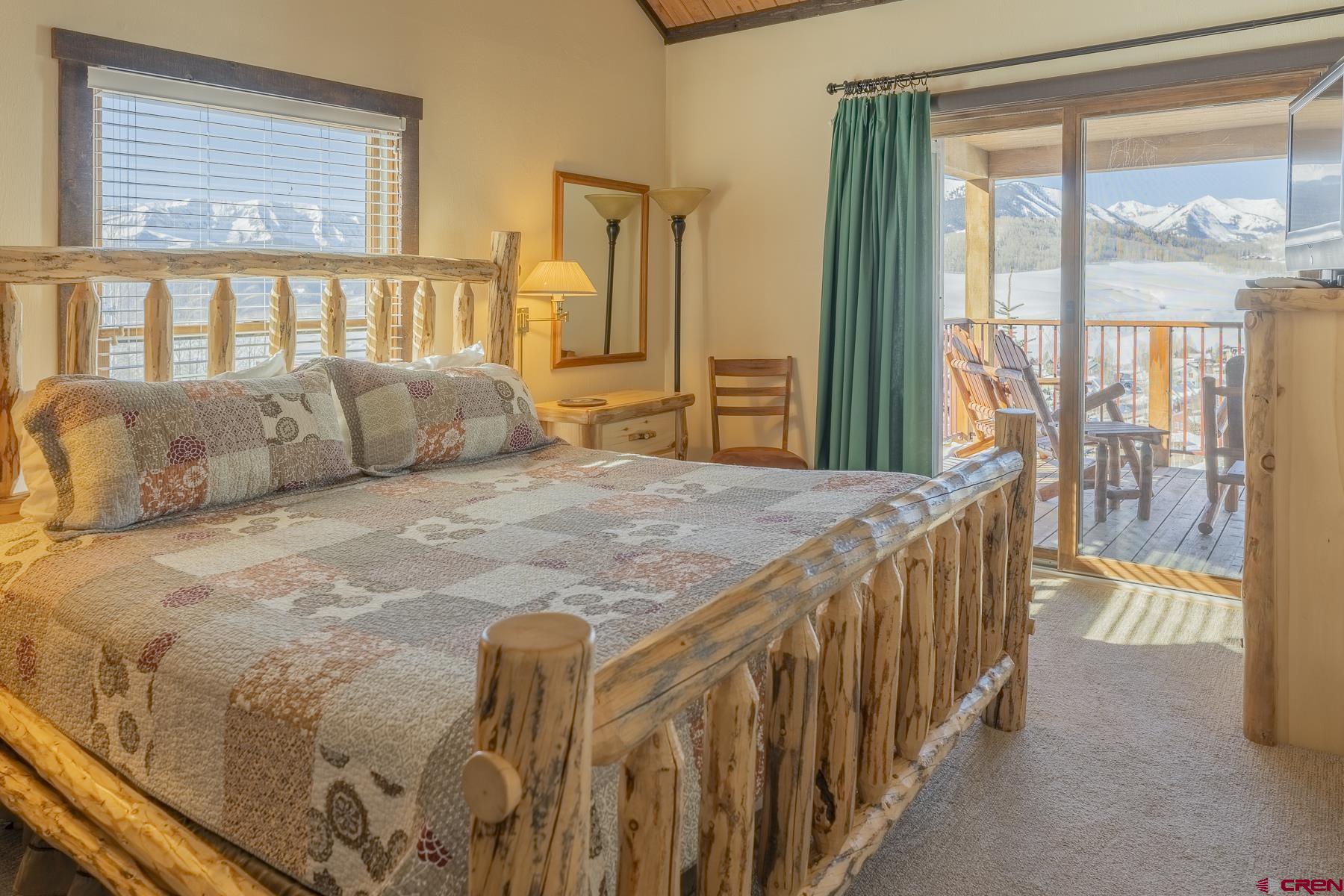 18 Hunter Hill Road, Unit J304 Crested Butte, CO 81225 - Photo 17 of 40 a bedroom with a large bed and a large window