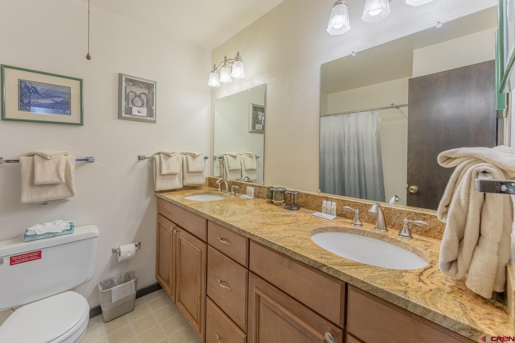 18 Hunter Hill Road, Unit J304 Crested Butte, CO 81225 - Photo 18 of 40 a bathroom with a granite countertop toilet sink and mirror