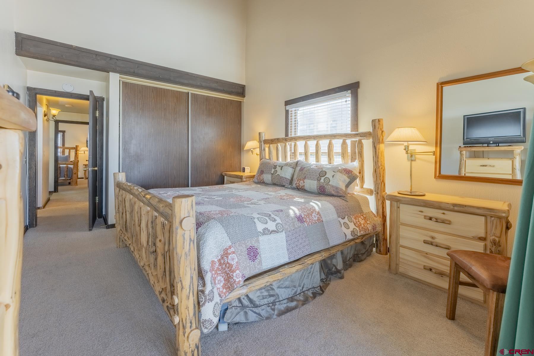 18 Hunter Hill Road, Unit J304 Crested Butte, CO 81225 - Photo 21 of 40 a bedroom with a bed and a dresser