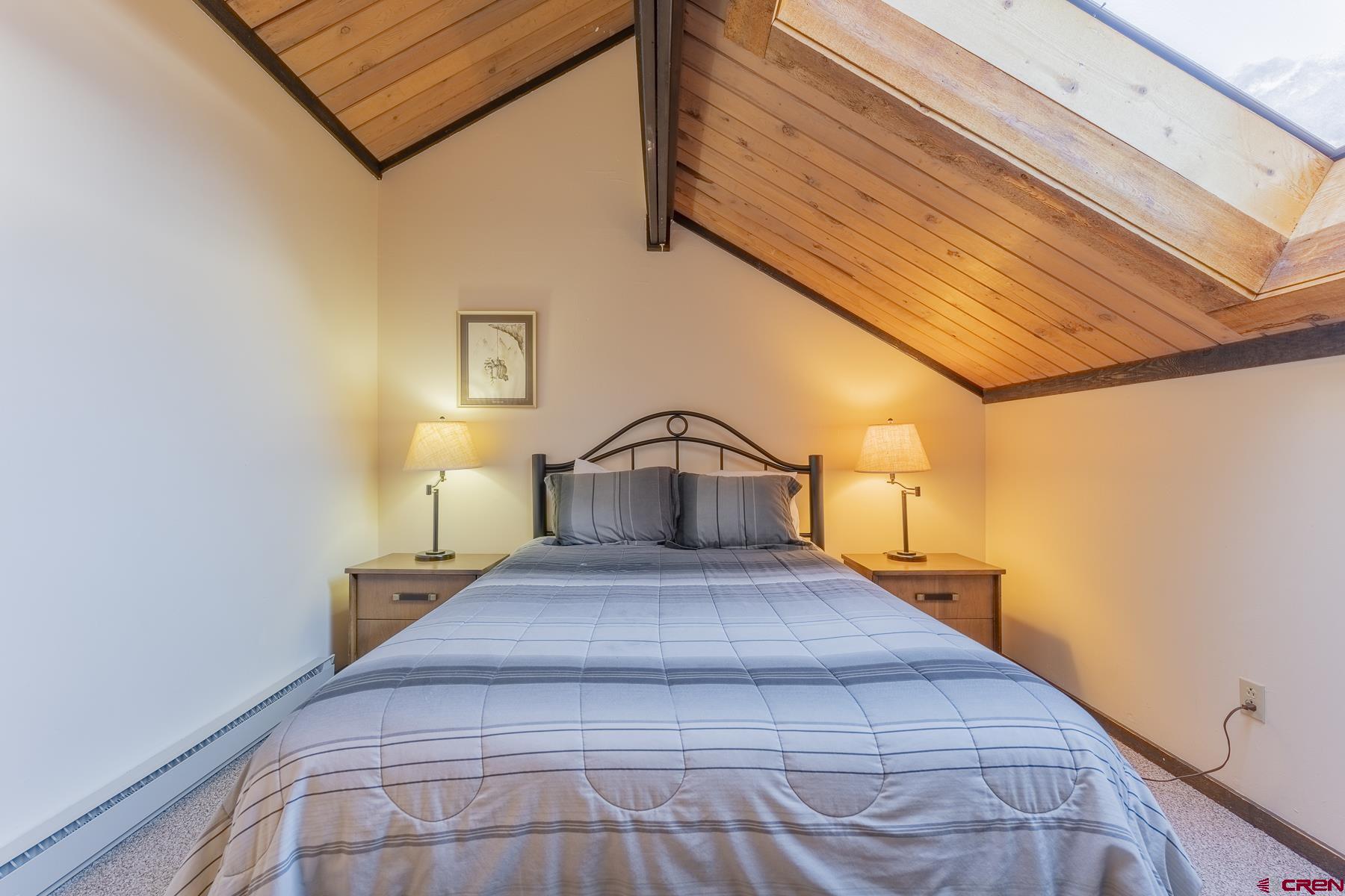 18 Hunter Hill Road, Unit J304 Crested Butte, CO 81225 - Photo 27 of 40 a bedroom with a bed and a night stand