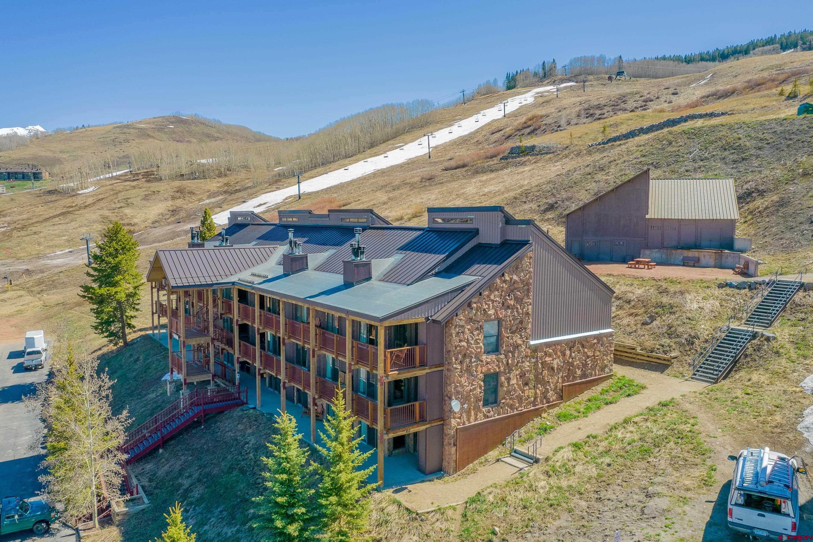 18 Hunter Hill Road, Unit J304 Crested Butte, CO 81225 - Photo 31 of 40 front view of a house with a big yard