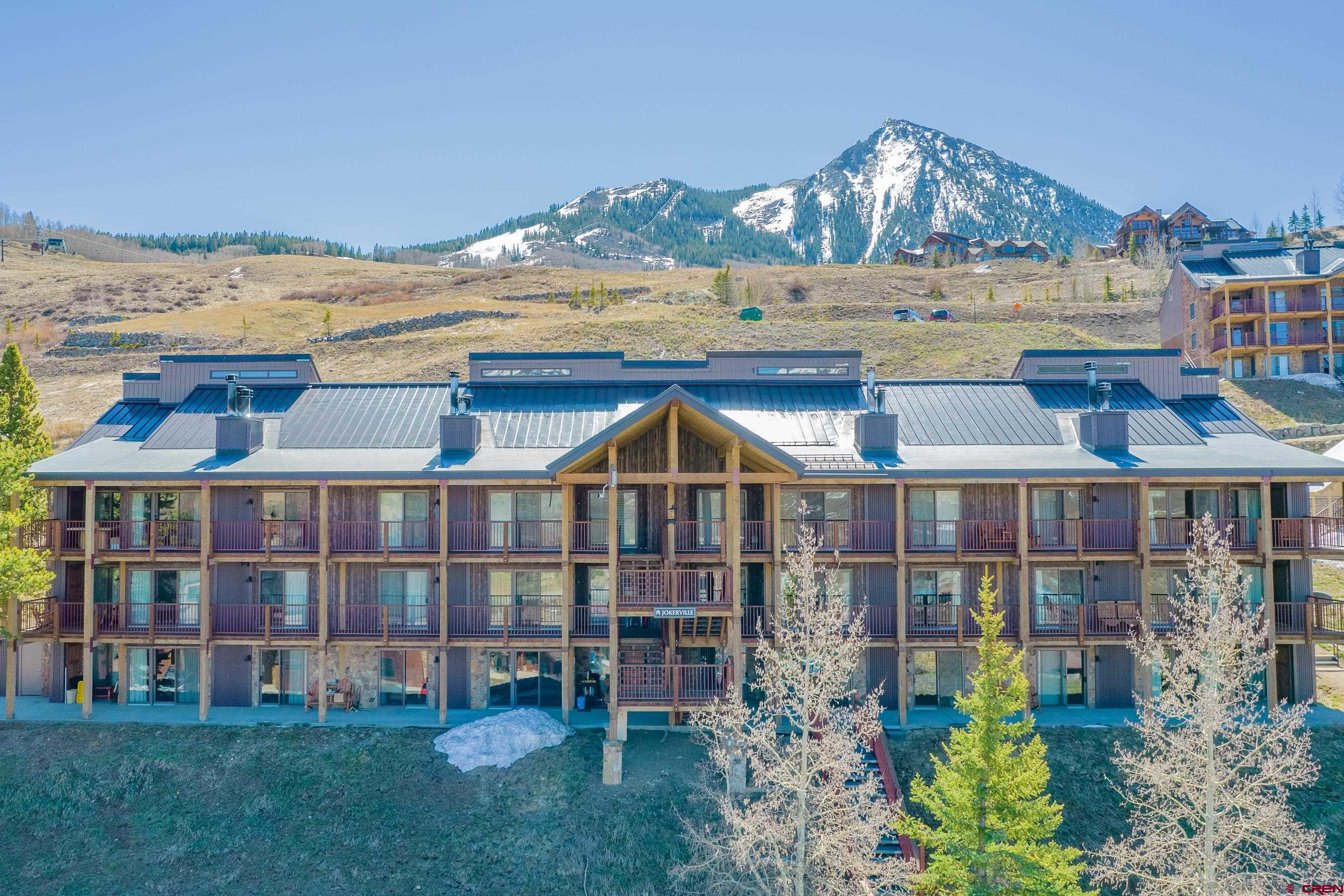 18 Hunter Hill Road, Unit J304 Crested Butte, CO 81225 - Photo 35 of 40 a view of a large building with a garden and plants