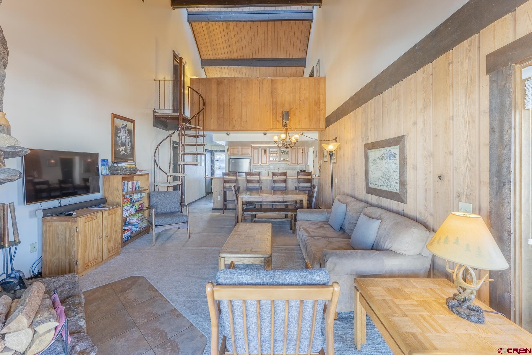 18 Hunter Hill Road, Unit J304 Crested Butte, CO 81225 - Photo 4 of 40 a living room with furniture and a flat screen tv