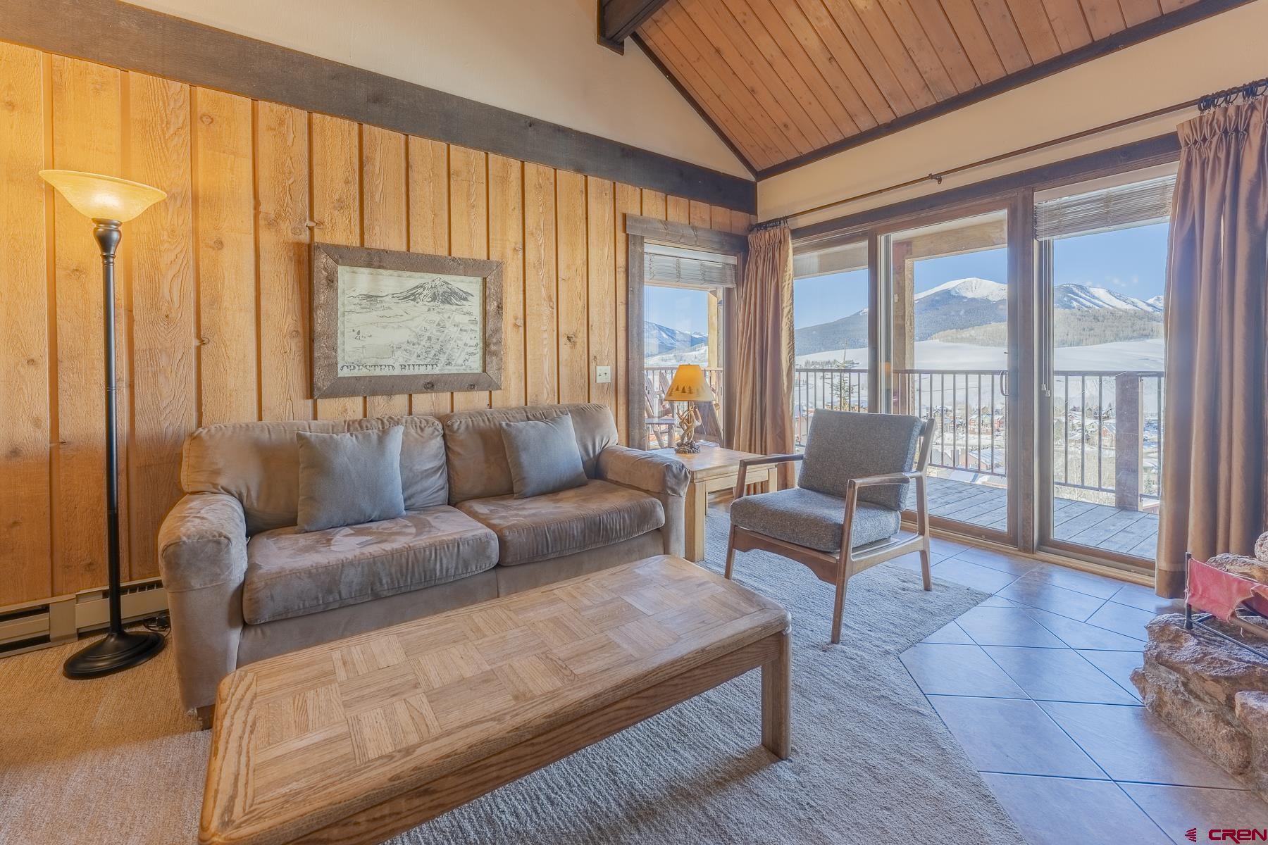 18 Hunter Hill Road, Unit J304 Crested Butte, CO 81225 - Photo 6 of 40 a living room with furniture and a large window