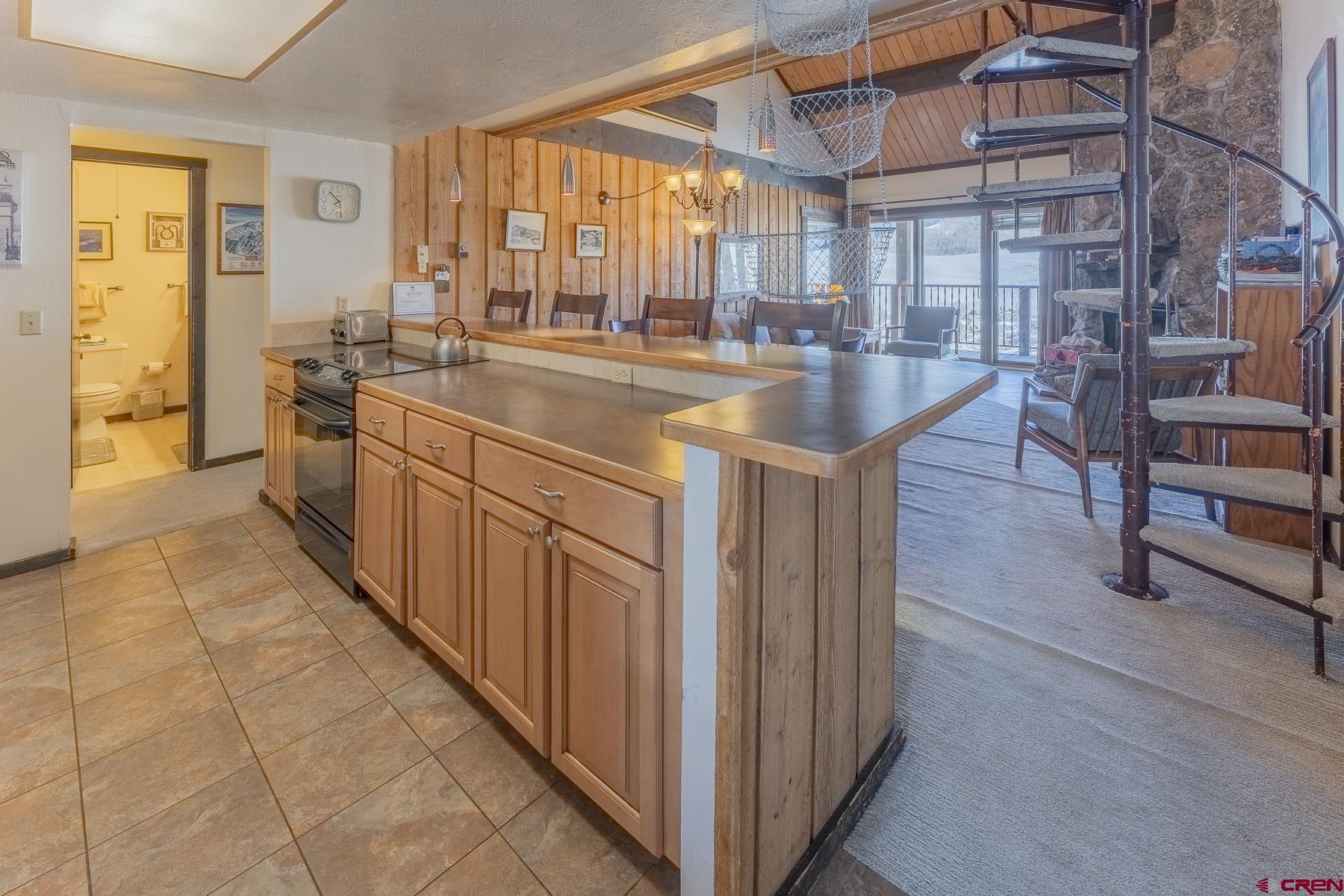 18 Hunter Hill Road, Unit J304 Crested Butte, CO 81225 - Photo 9 of 40 a kitchen with stainless steel appliances granite countertop a sink and cabinets