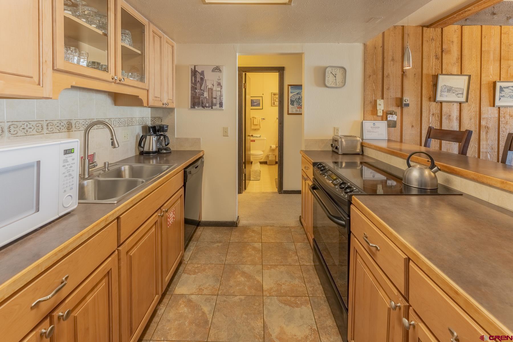 18 Hunter Hill Road, Unit J304 Crested Butte, CO 81225 - Photo 10 of 40 a kitchen with stainless steel appliances granite countertop a sink stove and cabinets