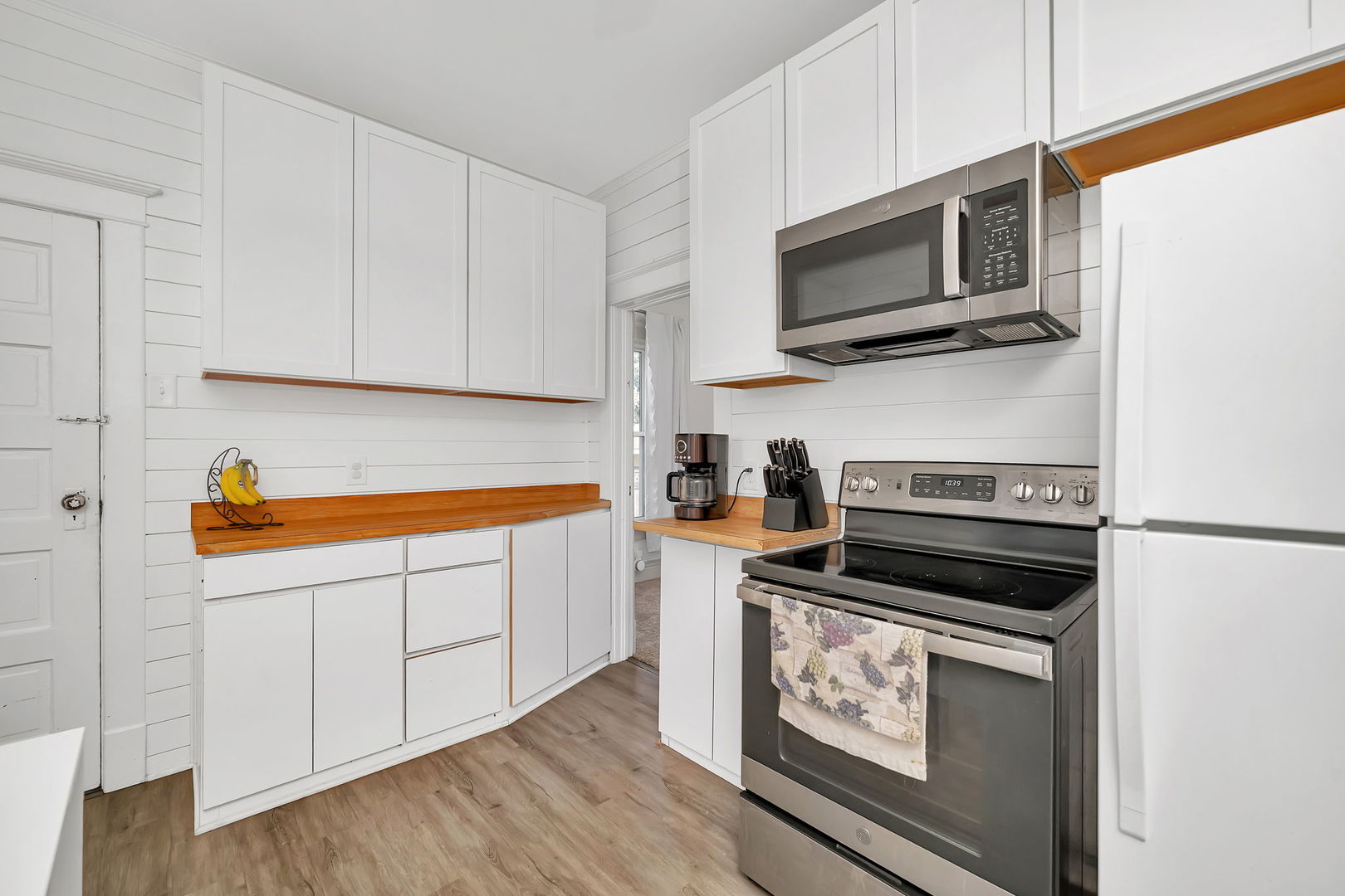 1122 Grant Street Morris, IL 60450 - Photo 15 of 25 a kitchen with stainless steel appliances a stove a microwave sink and cabinets