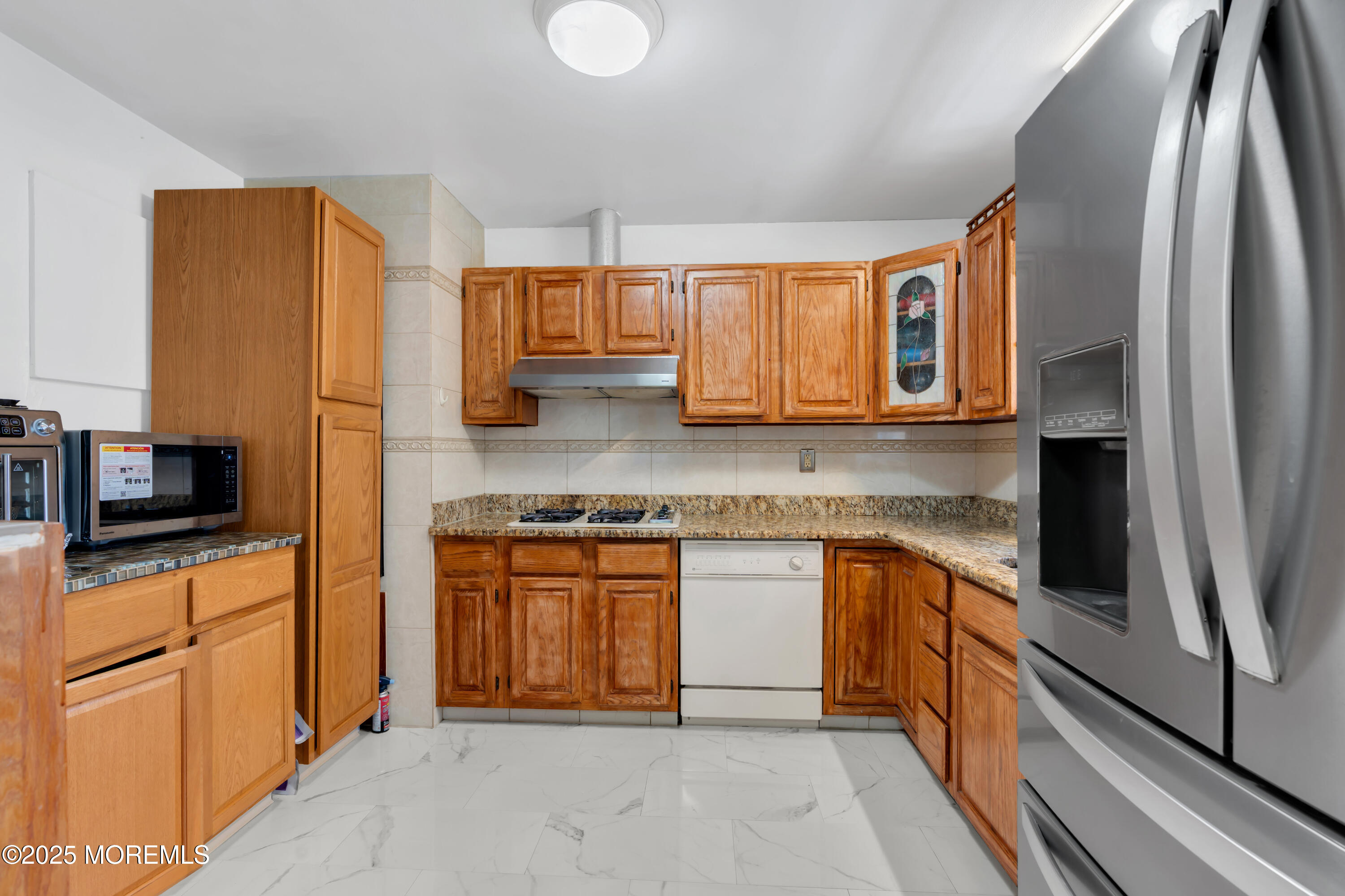 95 Marginal Road Jackson, NJ 08527 - Photo 7 of 24 a kitchen with stainless steel appliances granite countertop a refrigerator stove and sink