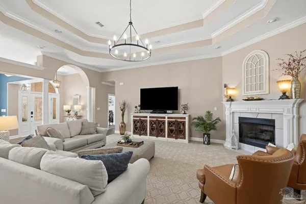 a living room with furniture a flat screen tv and a fireplace