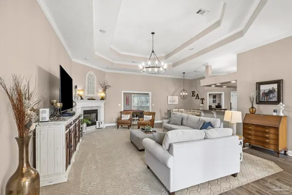 a living room with furniture a fireplace and a flat screen tv