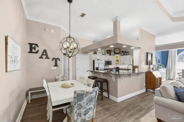 a living room with dining table and chairs