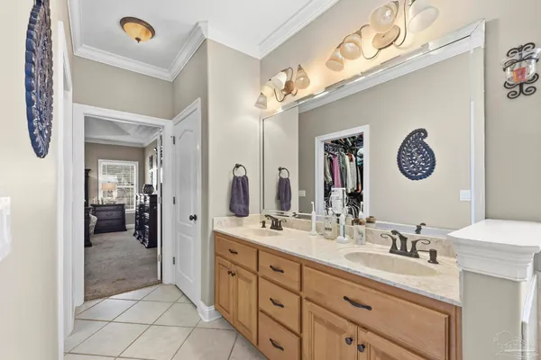 a spacious bathroom with a double vanity sink and a mirror