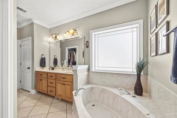a bathroom with a bathtub sink and mirror